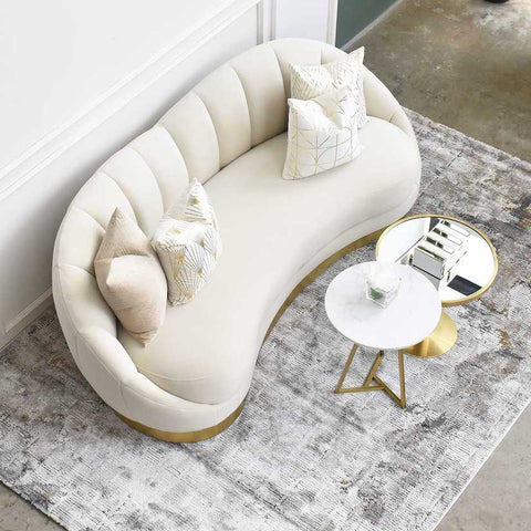 Cool grey Bastien rug balances the warm gold hues on the primrose sofa and the side tables.