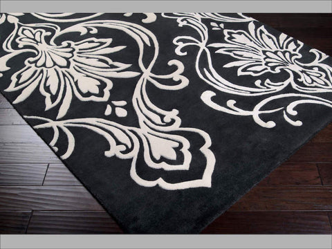 Hand-tufted of New Zealand wool, this Candice Olson plush rug exudes true art form with details of unique floral pattern in bold black and white. A conversation piece that enlivens any space.