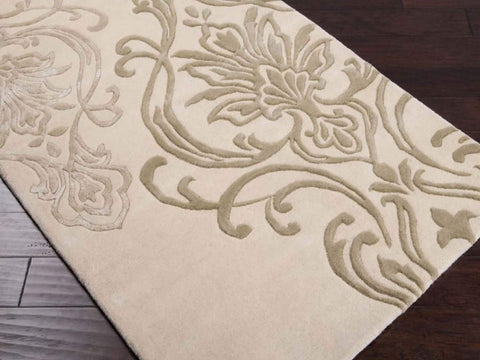 Hand-tufted of New Zealand wool, this Candice Olson plush rug exudes true art form with details of unique floral pattern in beige, sea foam and light gray. A conversation piece that enlivens any space.