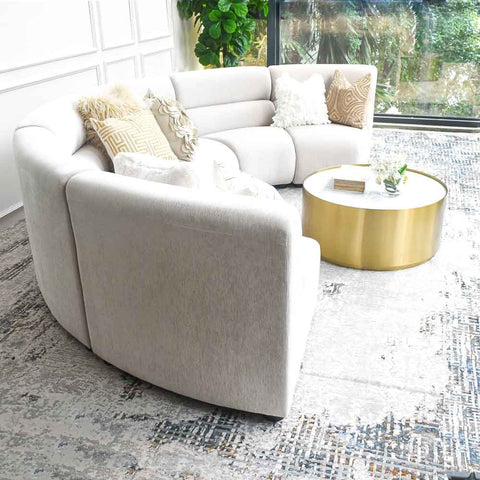 Cava 6-Seater Curved U-Shaped Modular Sofa in beige velvet, side view, detailing the plush cushions and modern feet for a sleek look.