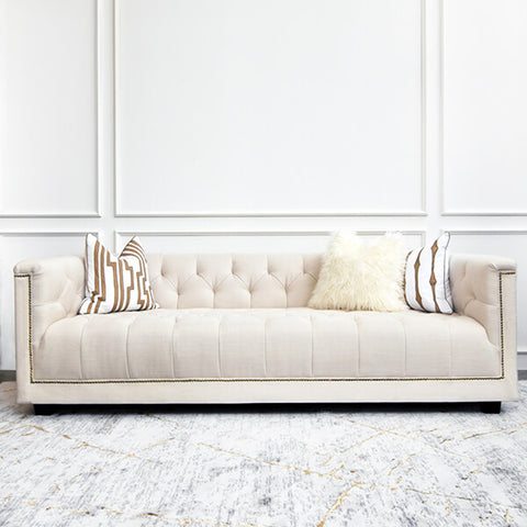 Duchess of Chesterfield sofa in ivory linen fabric material, modern vintage design with tufted back and seat, with cushion styling.