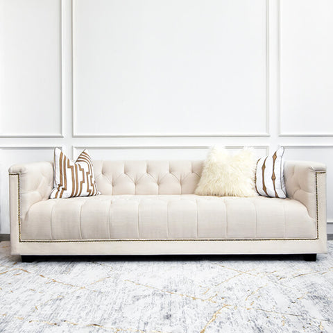 Front view of the Earl & Duchess sofa in ivory linen, styled with decorative throw pillows for a cozy, elegant look.