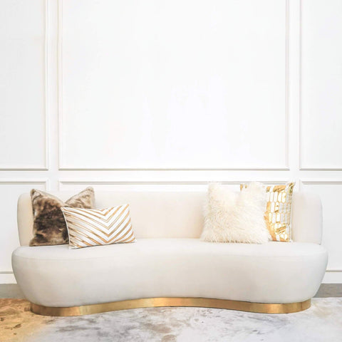 Eclipse modern Art Deco sofa design, curved Seats and gold base. Create a soft luxurious living room look with ivory and gold cushions.