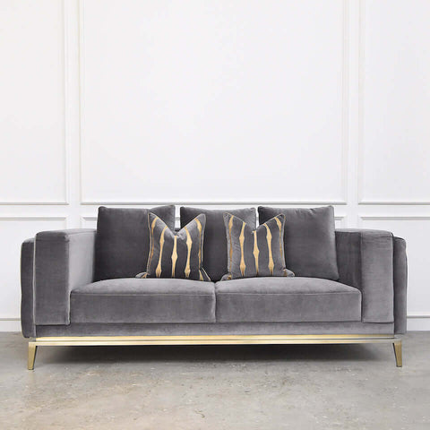 Grey velvet Fitzgerald sofa (front view) styled with Candice Olson cushions for a modern luxury appeal.