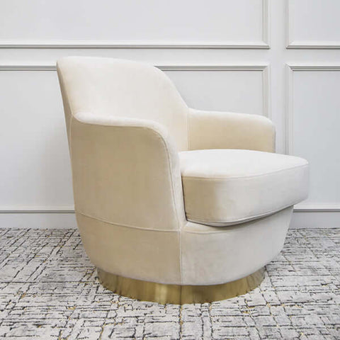 Side view of the Rever Armchair in velvet, showcasing its gently curved backrest and modern sculptural silhouette.