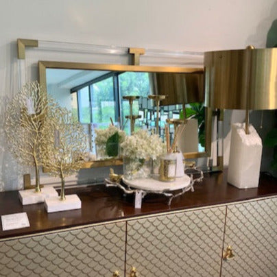 Acrylic Gold Wall Mirror (for Entrance Decor) sits on Elize 3-door cabinet decorated with white and gold themed decor.