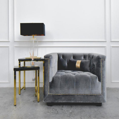 Earl Chesterfield Armchair paired with a black and gold side table and table lamp, styled in a sophisticated living room corner.