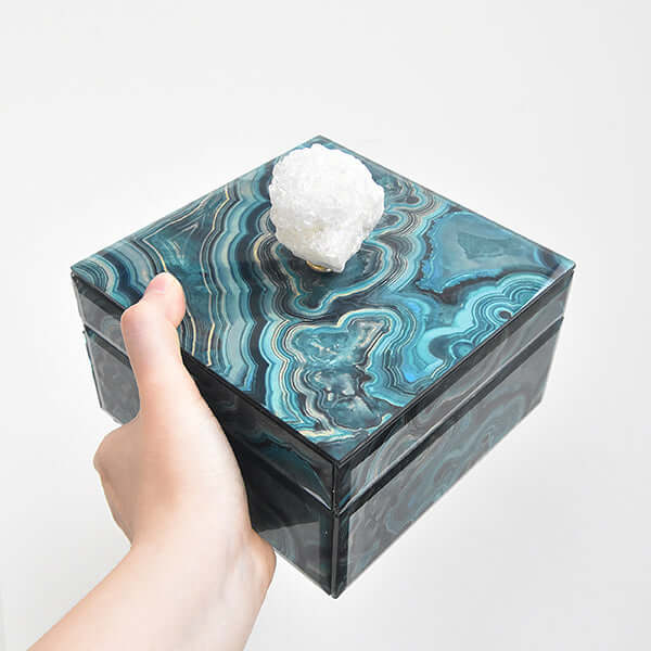 Side view of hand holding Artemis marble trinket box, crystal handle.