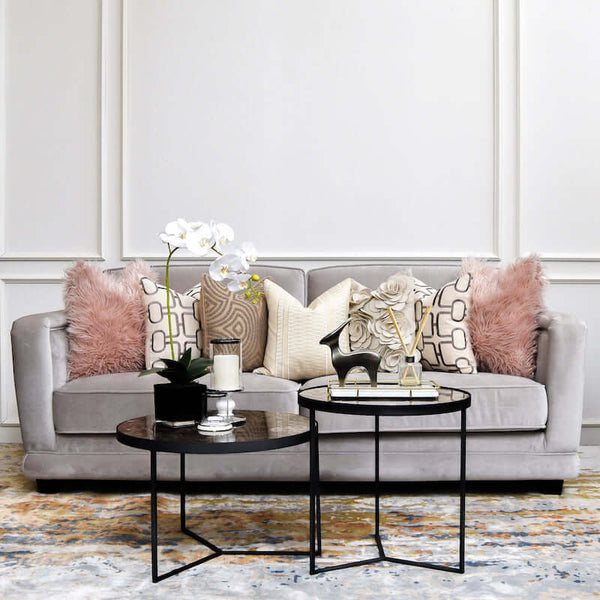 Adaliz Sofa styled in a living room, adorned with decorative cushions for a warm, inviting look for a high end 
living room.