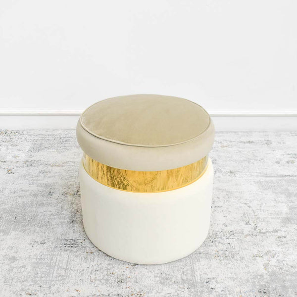 This Alba Ottoman Stool in Ivory cream and champagne color is ideal decor and as an extra seat for completing a modern living room.