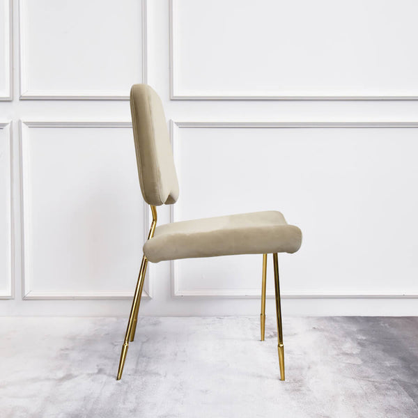 Side view of Artus dining chair, with lush champagne velvet seat.