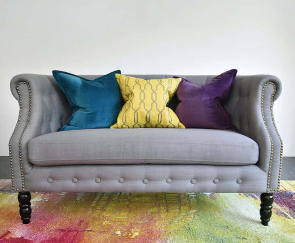 Multi coloured cushions on grey Fayette sofa.