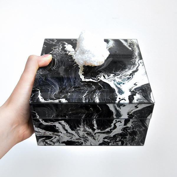 Black and white marble swirls on glass box, large natural raw stone handle.