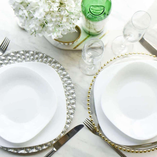 Silver and gold Barbican glass charger with white plates dining set up.