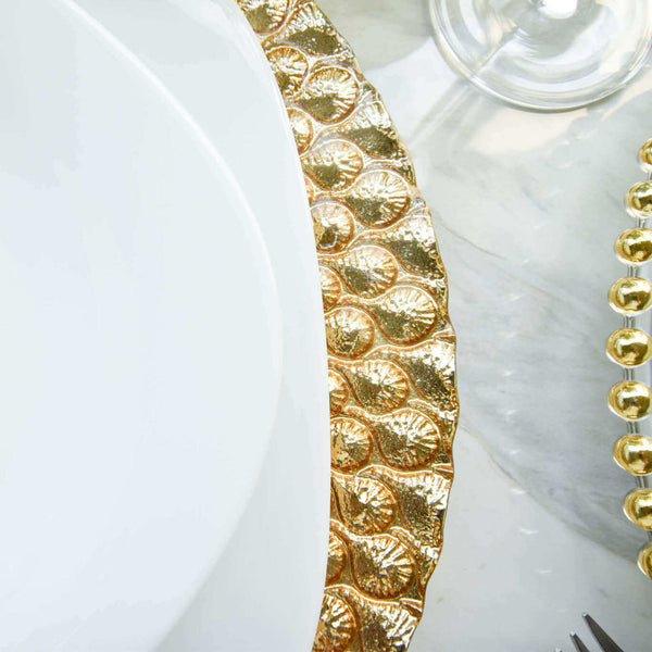 Zoom in image of scalloped details on gold glass charger.