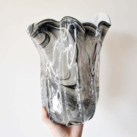 Zoomed in image of Bouges glass vase, reflective details on vase.