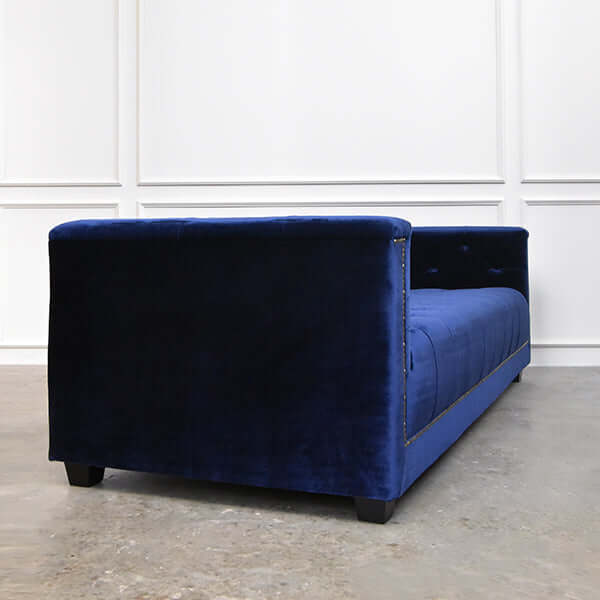 Side view of smooth creamy blue velvet on Chesterfield sofa.