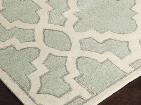 Zoomed in photo of the Candice Olson Lattice rug in a mint and ivory cream detail.