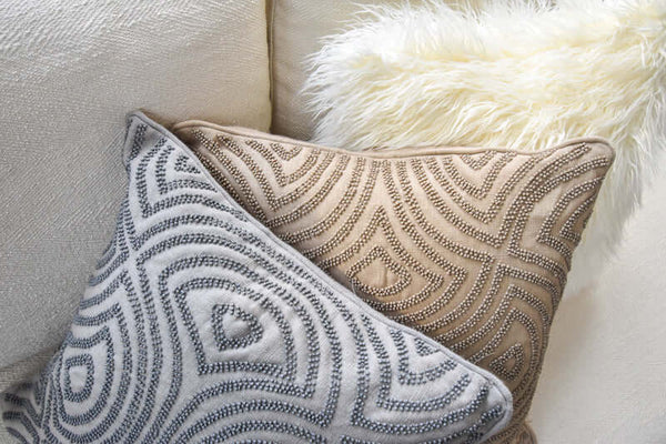 Grey Candice Olson cushion beside the beige Candice Olson cushion.