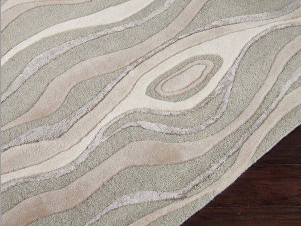 Made of 100% New Zealand wool, cotton canvas backing and hand tufted pieces.