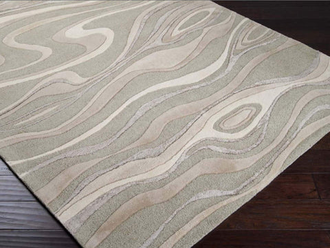 Hand-tufted of New Zealand wool, this Candice Olson plush rug exudes true art form with flowing details of unique patterns of different hues in light gray, beige and olive. A conversation piece that enlivens any space.