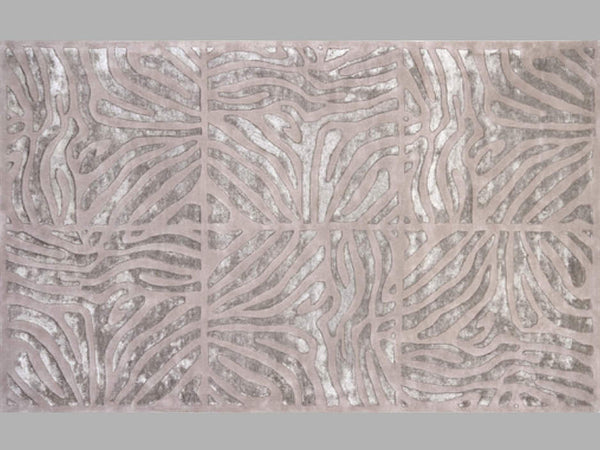 Hand-tufted of New Zealand wool, this Candice Olson plush rug exudes true art form with carved details of unique maze pattern in shades of gray and taupe. A conversation piece that enlivens any space.