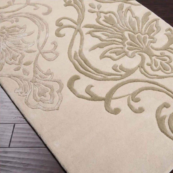 Hand-tufted of New Zealand wool, this Candice Olson plush rug exudes true art form with details of unique floral pattern in beige, sea foam and light gray. A conversation piece that enlivens any space.