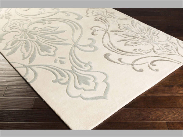 Hand-tufted of New Zealand wool, this Candice Olson plush rug exudes true art form with details of unique floral pattern in beige, sea foam and light gray. A conversation piece that enlivens any space.