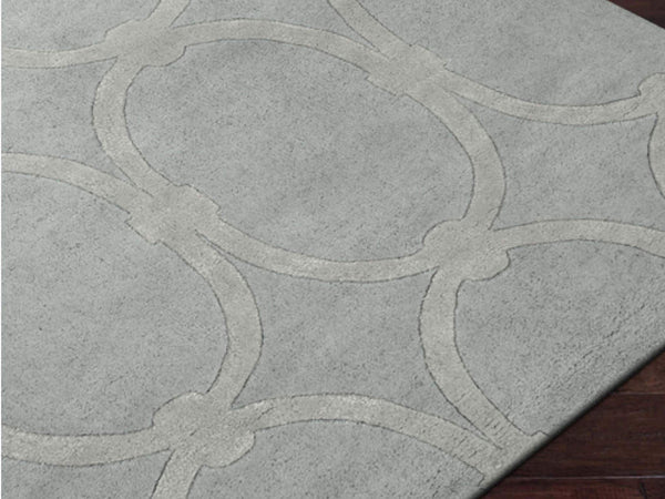Close up look of the Candice Olson Infinity Space rug in a medium grey tone and contrasting ring design.