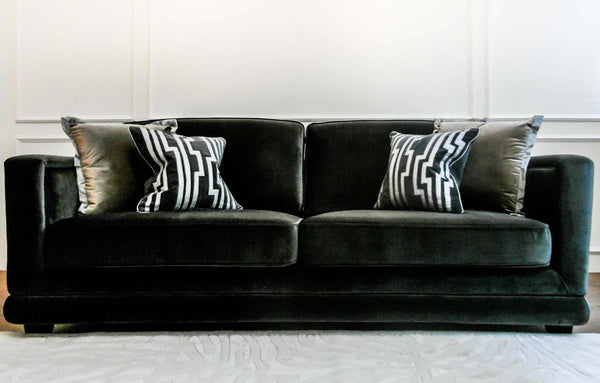 candice olson velocty cushion on black sofa.