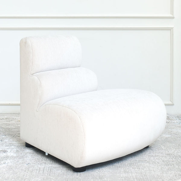 Cava 1-Seater Convex Modular Sofa Armchair in beige velvet, side view, showcasing its contemporary form and comfortable padding.