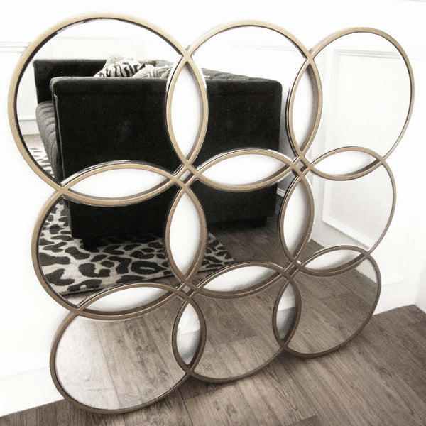 Decorative wall mirror with geometric patterns.