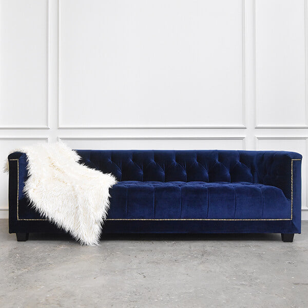 The Earl sofa in a deep blue hue, bringing a cool, elegant feel to its classic form.