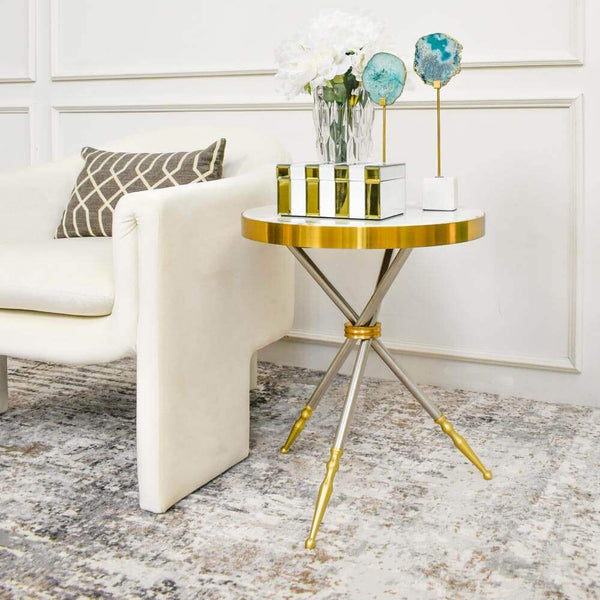 Side table with white cultured marble top and gold edges beside Parc Armchair.
