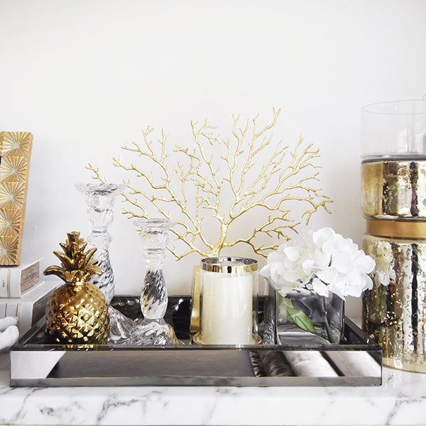 Create a luxurious themed look with mirrored and gold finishing decor pieces.