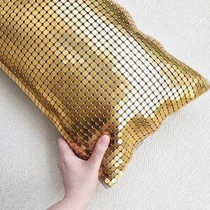 Dampierre Gold Throw Pillow is upholstered in matte gold mesh adds a vintage revival to modern living room decor.
