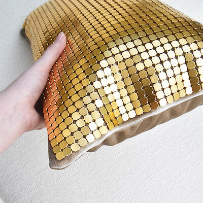 Held in hand, this Dampierre Gold Boudoir Cushion which is upholstered in matte gold mesh on one side and velvet on the other looks luxurious and stunning.