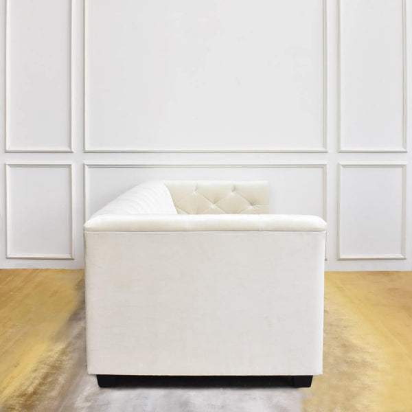 Side of Duchess Ivory Velvet sofa view on Evka Sun rug.