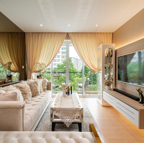The classic Duchess Chesterfield Sofa in plush ivory cream velvet provides affordable luxury in this stunning condo, expertly designed by Singapore's Ethan Interiors.