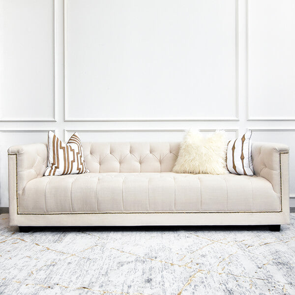 Front view of the Earl & Duchess sofa in ivory linen, styled with decorative throw pillows for a cozy, elegant look.
