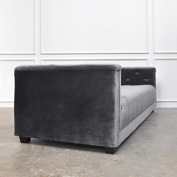 Side view of the Earl sofa in grey lush velvet, capturing the sheen and depth of the performance fabric.