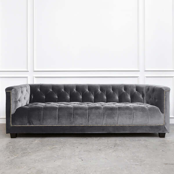 Front view of the Earl sofa in classic grey fabric, emphasizing its hand-tufted design and modern Chesterfield charm.