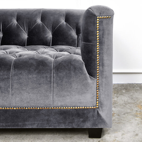 Zoomed in details of hand made nail head trim lines on Designer Sofa in Velvet Singapore.