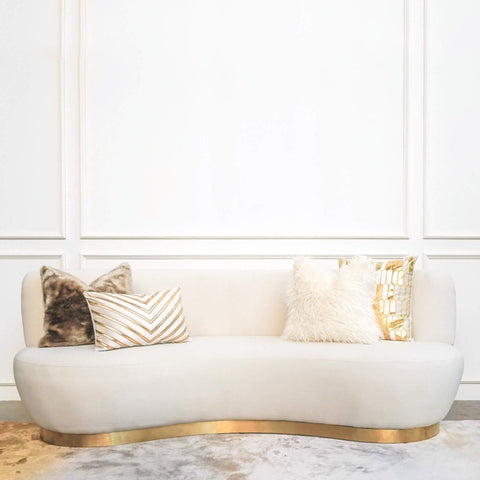 Eclipse modern Art Deco sofa design, curved Seats and gold base. Create a soft luxurious living room look with ivory and gold cushions.