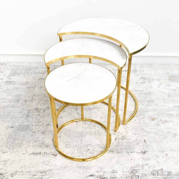 Side view of the Eden polished gold stainless steel side table. It gives a modern luxurious vibe for a timeless living room design.