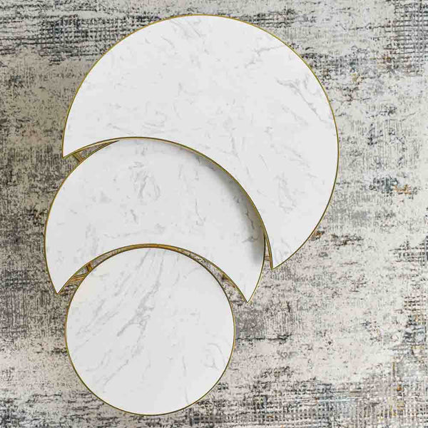Eden Marble Nesting Coffee Table Set (Set of 3) with 3 eclipsed pieces' individual top views. Each table rim is lined with stainless steel in gold with inset marble top.