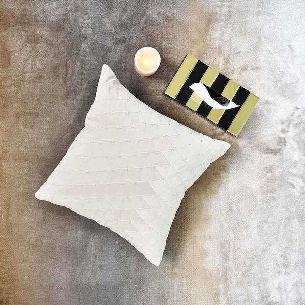 Create a warm living room setting with the Paige Stitched Cushion in Velvet Taupe, Kassie Black and Gold tissue box and LED candles.
