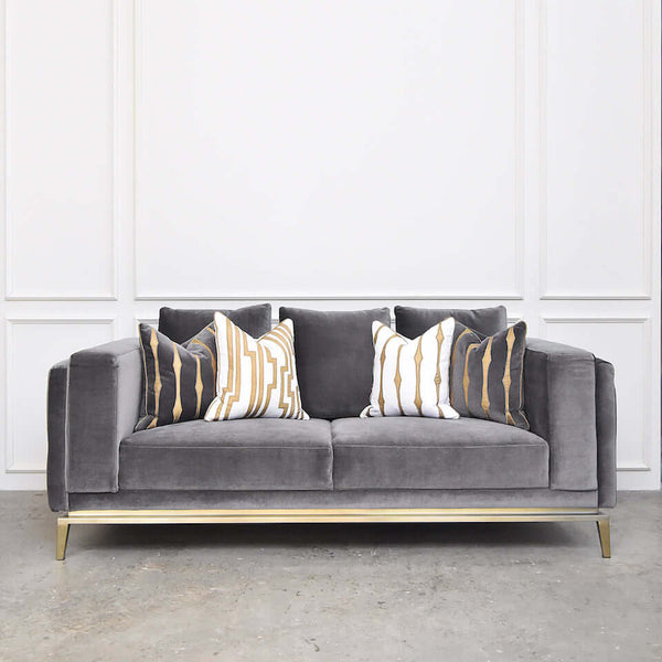 Grey velvet Fitzgerald sofa (front view) styled with Candice Olson cushions for a modern grey and white monochromatic interior design.