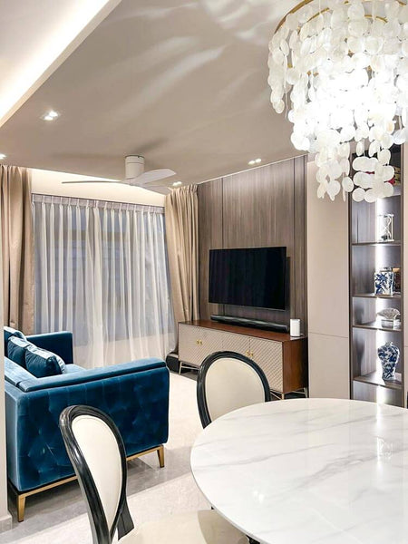 Blue high-shine velvet Fitzgerald sofa in upscale living room with Elize TV console.