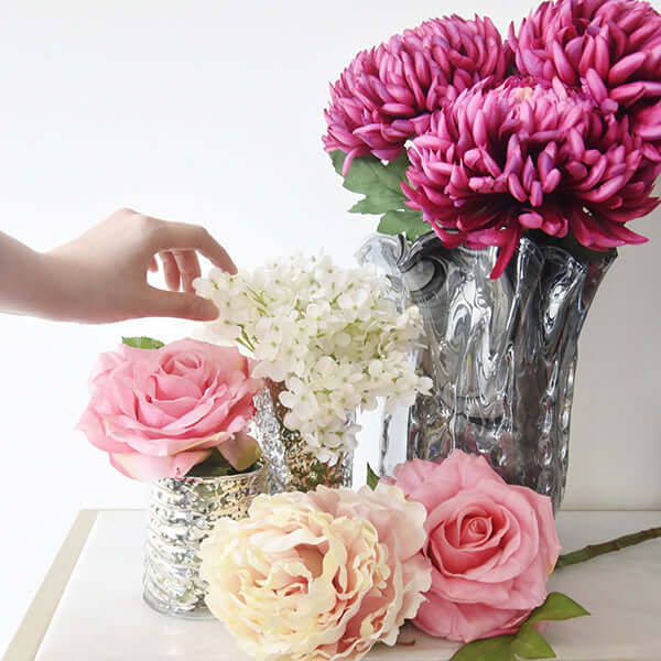 Purple, Pink and Ivory faux flower arrangements.